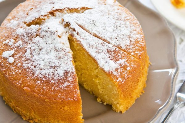 Butter cake with orange zest and juice by coffee