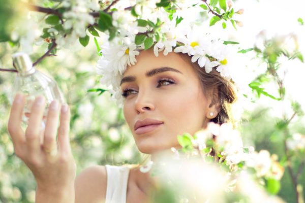 Sensual woman with perfume bottle