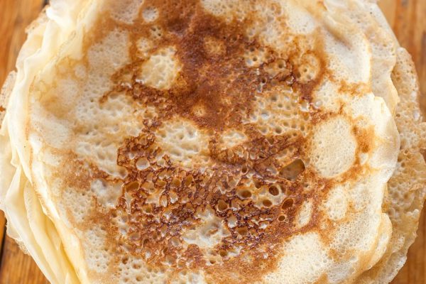 stack of pancakes on a wooden table
