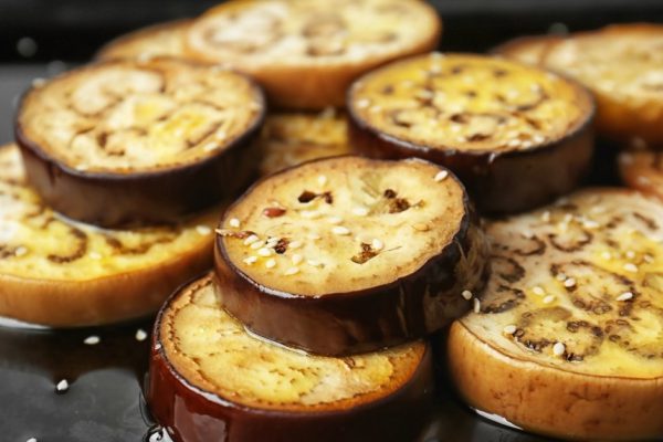 Sliced eggplant on baking tray, closeup