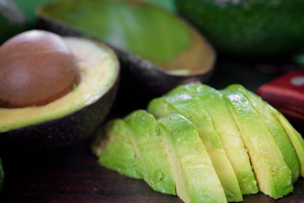 Peeled ripe avocado on the chopping board