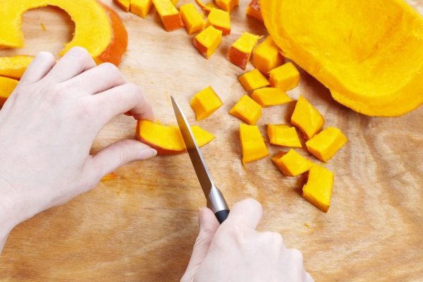Chopping pumpkin. Making vegetable dish