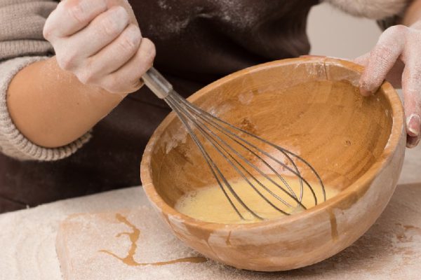 Unrecognizable woman preparing dough, closeup photo