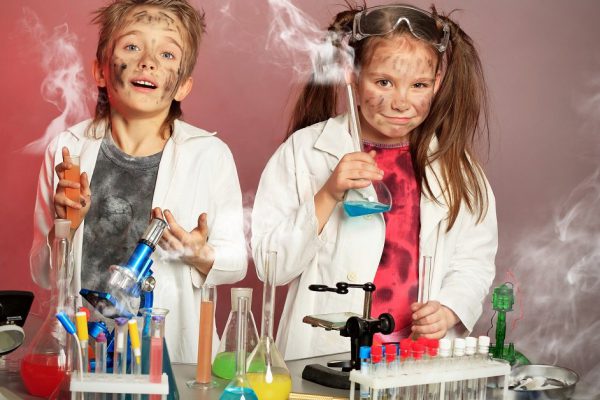 Two children making science experiments. Education.