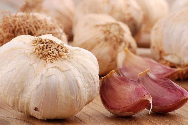cloves of garlic on wooden table