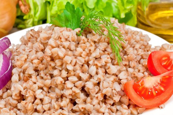 buckwheat groats in a bowl on a wooden table