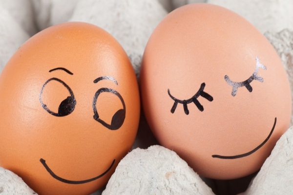 two funny smiling eggs in a packet.