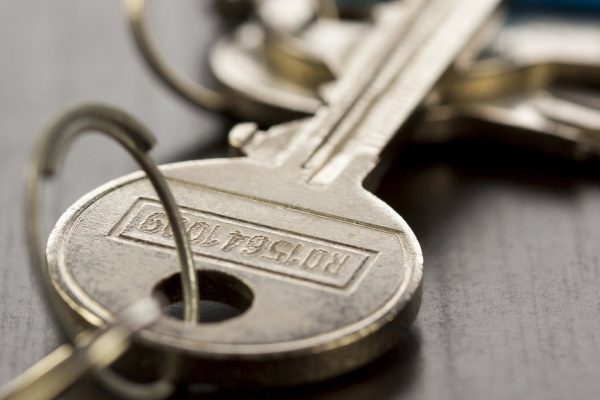 Macro Shot of Conceptual House Keys on Top of Wooden Table