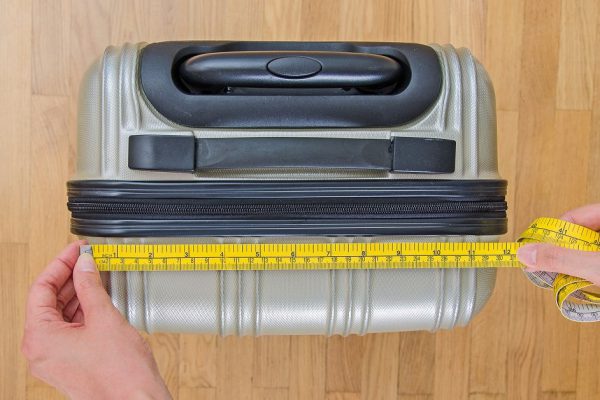 Hand luggage measurement using measuring tape.
