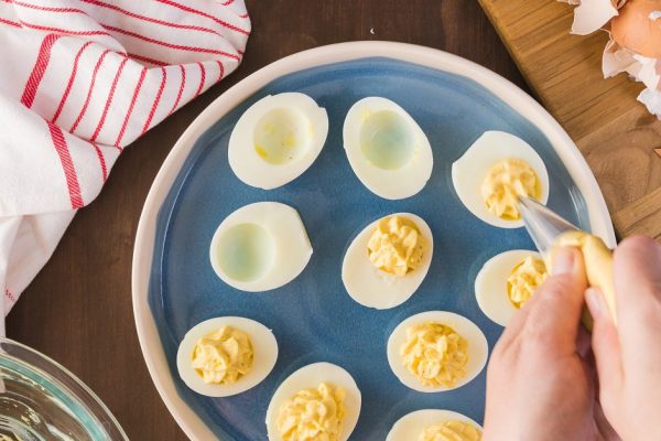 Preparing deviled eggs with organic eggs for appetizer. Step by step recipe.