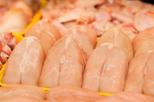 Fresh carcasses of the chickens on shelf in supermarket