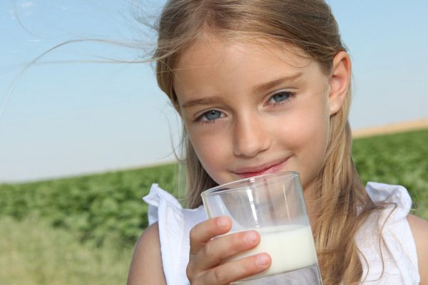 Closeup of little girl drinking milk