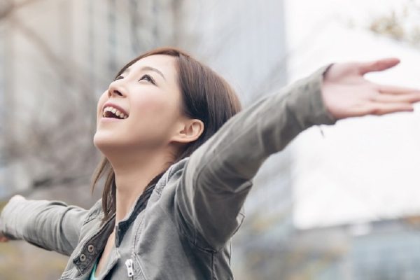 Asian beauty open arms and feel free in the city.