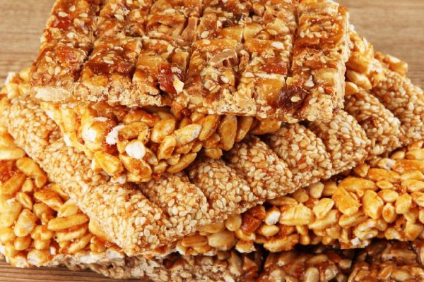 tasty sweets (kozinaki), on wooden background