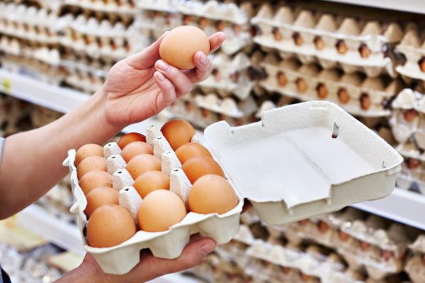 In the hands of a woman packing eggs in the supermarket