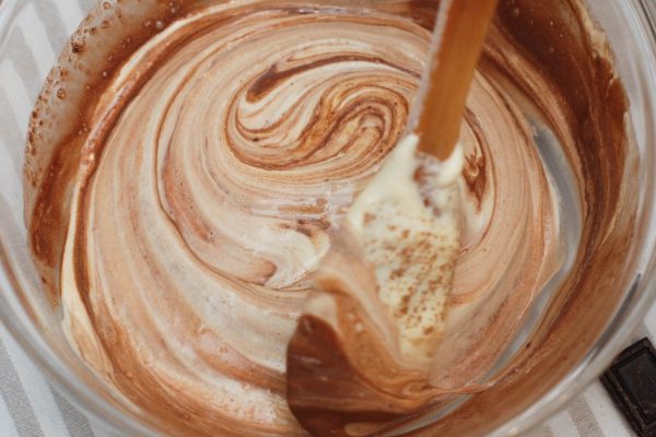Mixing with Wooden Spoon Butter Dough in Glass Bowl. Cooking Chocolate Pie.