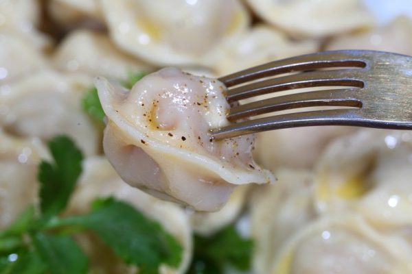 Pelmeni with sour cream, the butter ground by pepper and fresh parsley