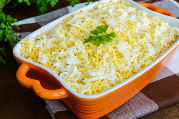 Light spring salad with boiled vegetables, eggs and sardines in oil. Slavonic traditional dish of "Mimosa".