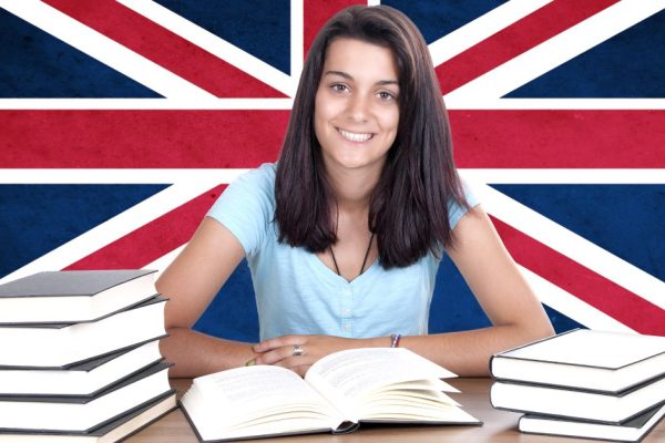 young girl student pc on the background with UK flag. English language learning concept