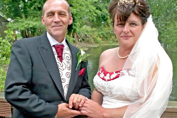 A Bride and Groom smiling at their reception after the wedding.
