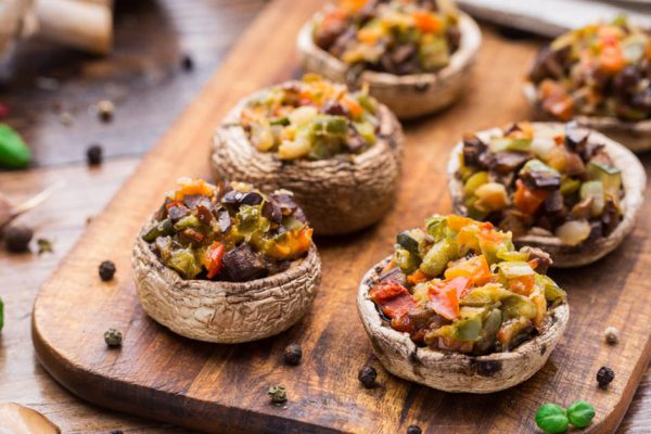 Portobello mushrooms stuffed with tomato, paprika, and mozzarella cheese.