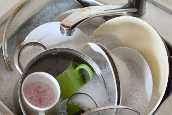 Dirty dishes and unwashed kitchen appliances filled the kitchen sink