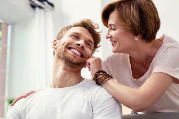 My dear son. Joyful nice woman looking at her son while showing her love to him
