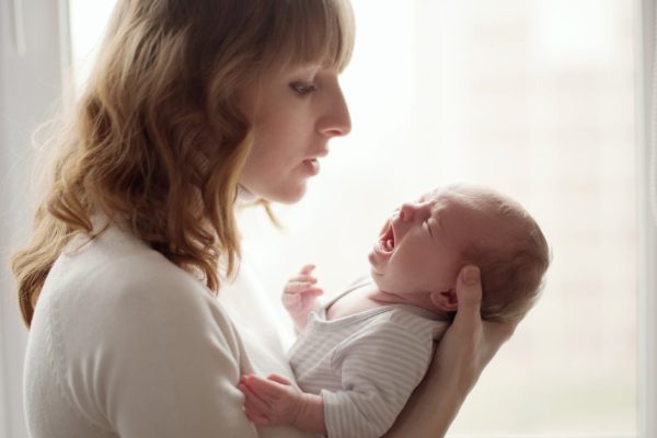 young mother with cute little crying baby