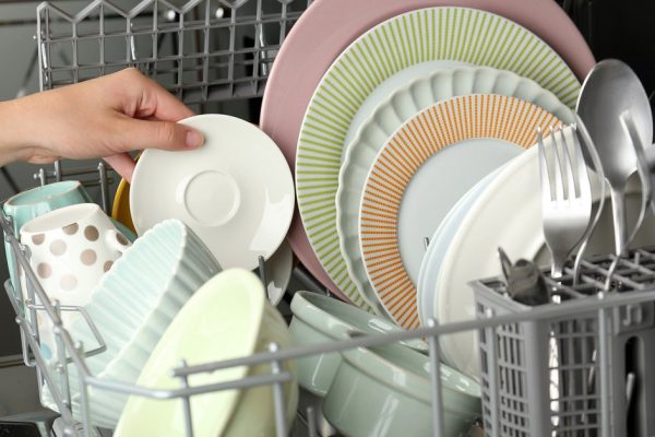 Open dishwasher with clean utensils in it