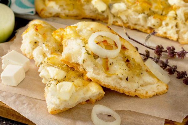 Focaccia with cheese, Italian bread on a wooden table