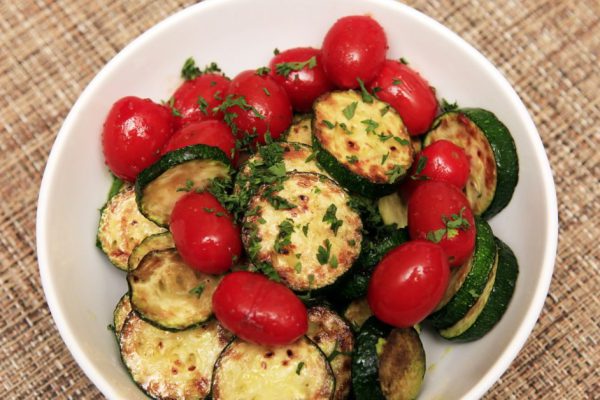 Fried zucchini and tomatoes with herbs