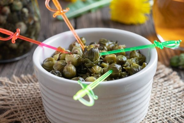 False capers made from young dandelion buds on a table