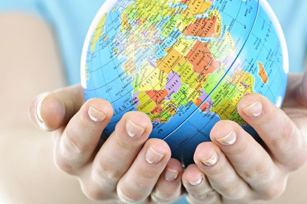 Hands holding globe