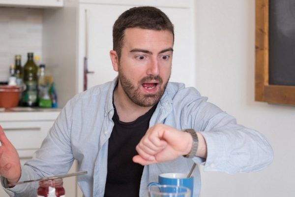 Man having breakfast but too late to go to job