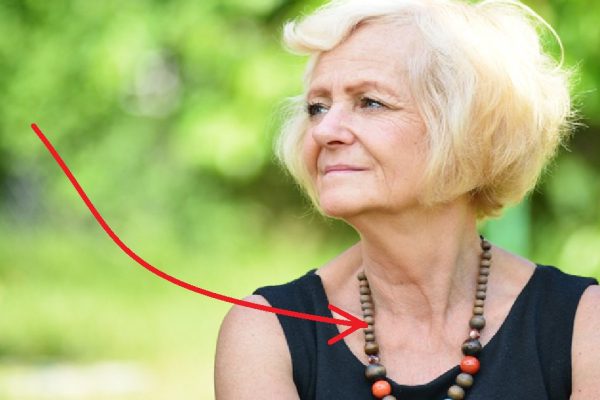 Mature, blonde woman in garden,