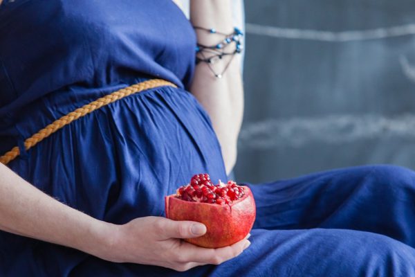Man embraces his pregnant woman