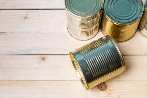 Tin cans for food on wooden background