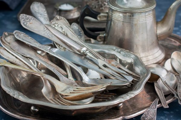 Vintage old utensils made of nickel silver, tableware (kettle, teaspoons, tablespoons, knives, forks, tray, dish), horizontal, space for text
