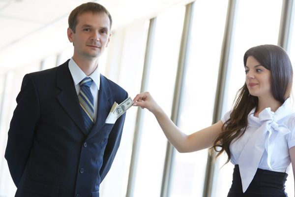 woman pulls out of pocket businessman bill