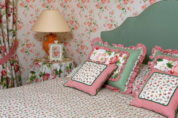 Interior of a bedroom with a lamp pillows a vegetative ornament