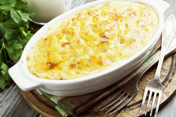 Potato casserole with meat on the wooden table