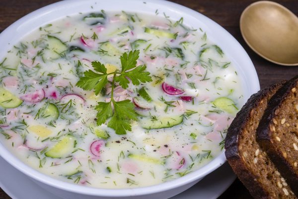 Close up of russian cold vegetable soup on yogurt, sour-milk base - okroshka