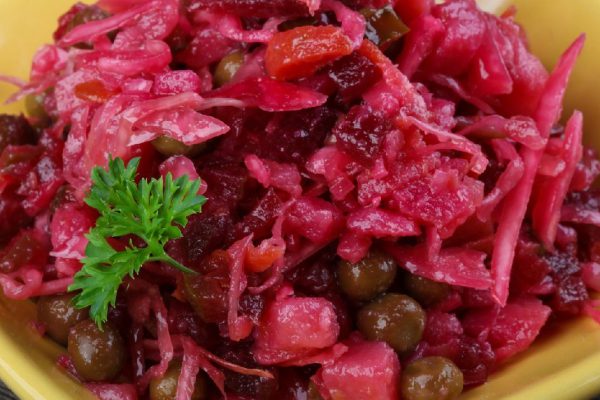 Viniagrette russian salad served parsley on wood background