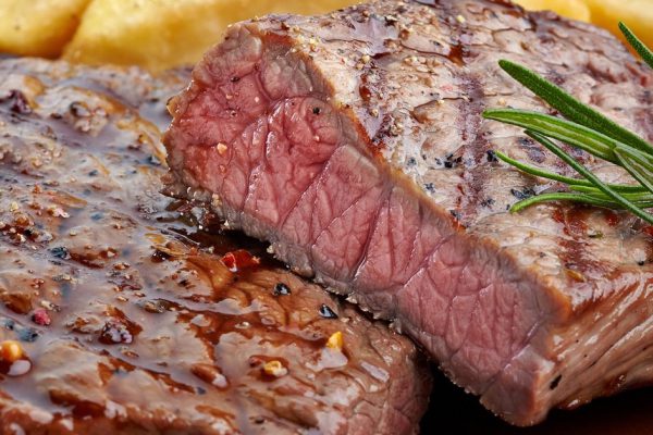 grilled beef steak on wooden cutting board