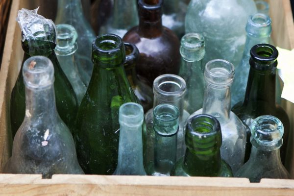 Pastel Antique bottles in wood crate, London, UK