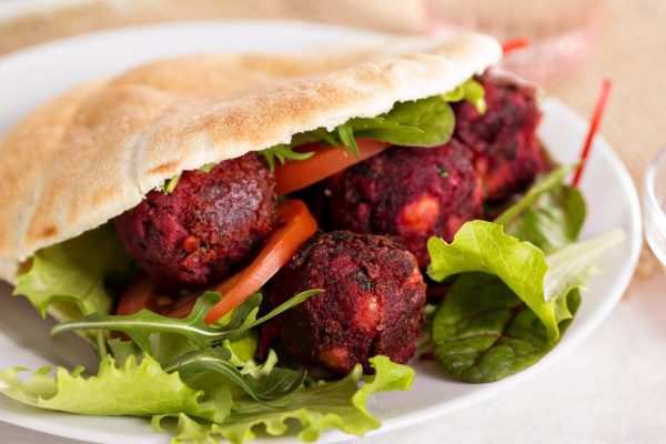 Beetroot falafel served with salad in a pita