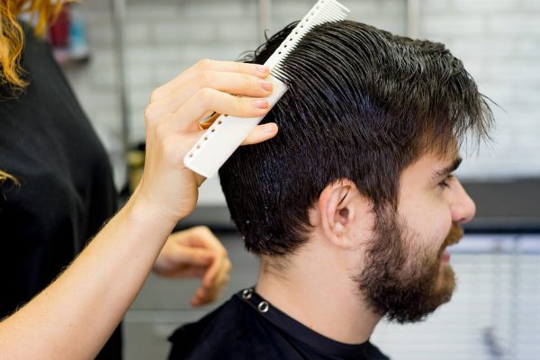 A portrait of a barber dressing hair