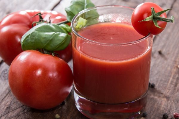 Tomato Juice with fresh Tomatoes on wooden background