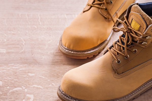 horizontal view very close up view two working shoes On Wooden Board