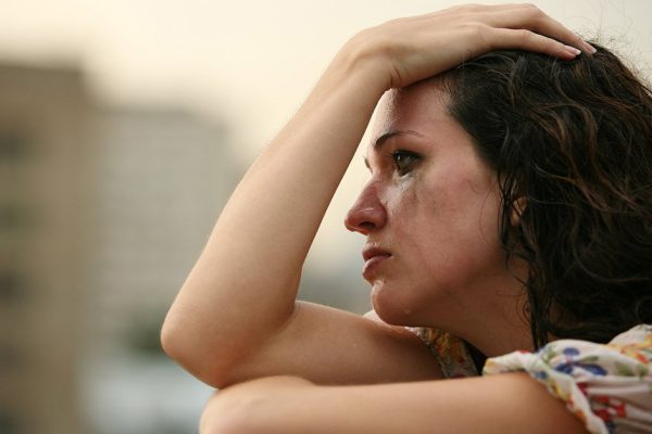 The lonely girl cries in the street